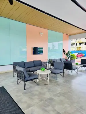 a lobby with chairs and a table in a building at Condo Stay Near SM City Santa Rosa Mall in Ibaba