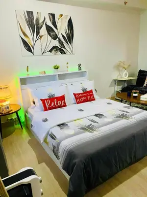 a bedroom with a large bed with red pillows at Condo Stay Near SM City Santa Rosa Mall in Ibaba