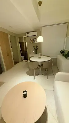 a living room with a table and a couch at Best Value-Beautiful 1BR in the Heart of Makati w WiFi, washer-dryer, pool & gym in Manila