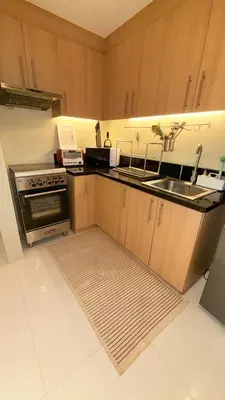 a kitchen with a sink and a stove at Best Value-Beautiful 1BR in the Heart of Makati w WiFi, washer-dryer, pool & gym in Manila