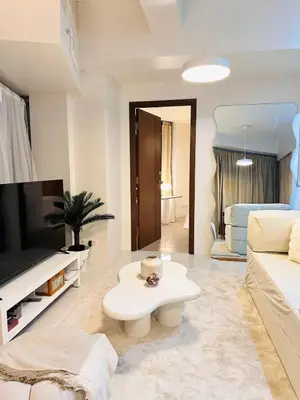 a living room with a white couch and a table at The Dreamy Cloud by Kozy Mood in Manila