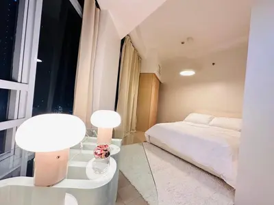 a bedroom with a bed and two lamps and a window at The Dreamy Cloud by Kozy Mood in Manila
