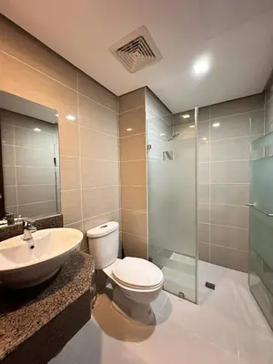 a bathroom with a toilet and a sink and a shower at The Dreamy Cloud by Kozy Mood in Manila