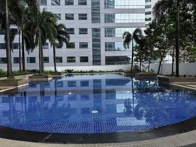 a large blue swimming pool in front of a building at The Dreamy Cloud by Kozy Mood in Manila