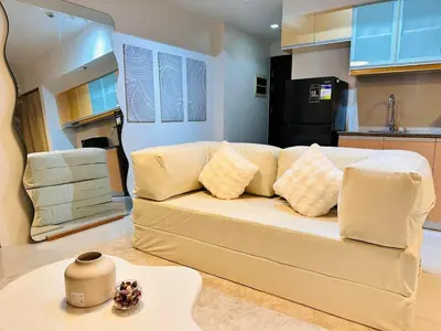 a living room with a couch and a kitchen at The Dreamy Cloud by Kozy Mood in Manila