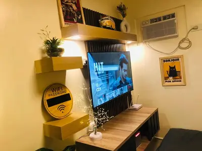 a living room with a television on a table at Dos Staycation Urban Deca Cubao in Manila