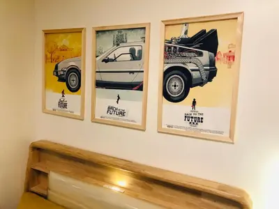 a wall with four posters on a wall at Dos Staycation Urban Deca Cubao in Manila