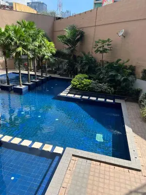 a large swimming pool with blue water in a building at Singapore Theme Sunshine 100 Tower 3 Pioneer Free Pool Gym Internet Netflix in Manila