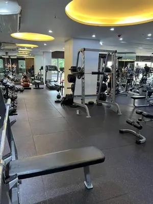 a gym with several tread machines in a room at Singapore Theme Sunshine 100 Tower 3 Pioneer Free Pool Gym Internet Netflix in Manila