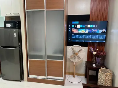 a kitchen with a refrigerator and a fan at Singapore Theme Sunshine 100 Tower 3 Pioneer Free Pool Gym Internet Netflix in Manila