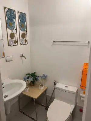 a white bathroom with a toilet and a sink at Greece Theme Boni MRT Train Edsa 1BR with Netflix Fast Internet Pool Light Mall in Manila