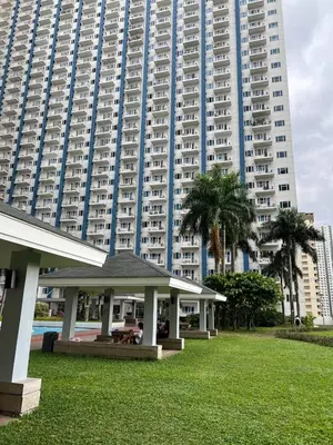 a gazebo in a park in front of a large building at Greece Theme Boni MRT Train Edsa 1BR with Netflix Fast Internet Pool Light Mall in Manila