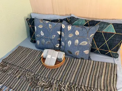 a purse sitting on top of a bed with pillows at Greece Theme Boni MRT Train Edsa 1BR with Netflix Fast Internet Pool Light Mall in Manila