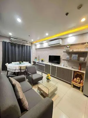 a living room with a couch and a table at Staycation Near Mall of Asia in Manila