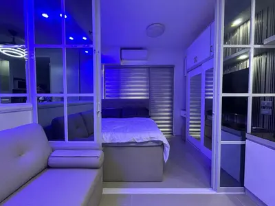 a bedroom with a bed and a couch in a room at E&T staycation in Manila