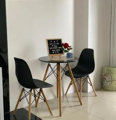 a table with two chairs and a laptop on it at Zia Preaecious Stay in Manila