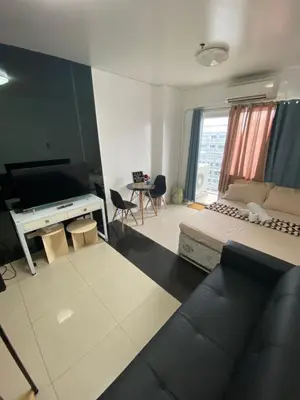 a living room with a couch and a desk at Zia Preaecious Stay in Manila