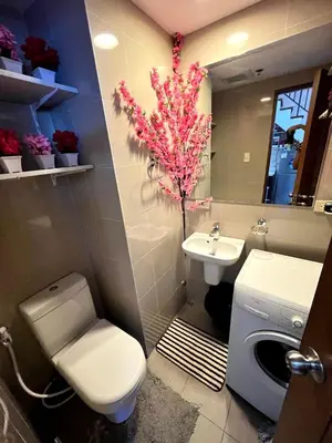 a bathroom with a toilet and a sink and a flower at Osaka Japan Theme Greenbelt Glorieta Makati Big Unit Loft 50sqm Free Pool Gym Netflix in Manila
