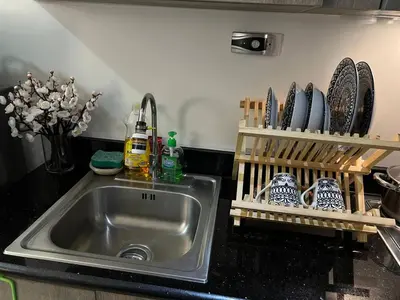 a kitchen counter with a sink and utensils at Japan Vibe Shaw MRT Train EDSA 1BR with Veranda Netflix Internet Pool View in Manila