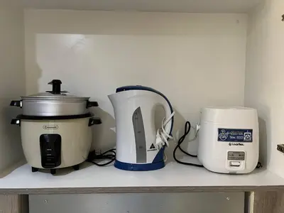 a counter with a coffee maker and a toaster on it at Japan Vibe Shaw MRT Train EDSA 1BR with Veranda Netflix Internet Pool View in Manila