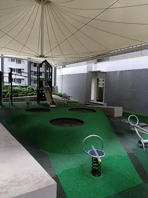 a building with a green golf course with a large tent at Japan Vibe Shaw MRT Train EDSA 1BR with Veranda Netflix Internet Pool View in Manila