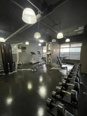 a gym with several rows of exercise bikes and lights at A Venue Residences 80N in Manila