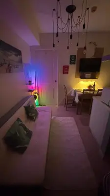 a bedroom with a bed in a room with purple lights at 2- Bedroom Condo in Metro Manila - Azure Beach in Manila