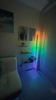 a bedroom with a bed with a green and purple light at 2- Bedroom Condo in Metro Manila - Azure Beach in Manila