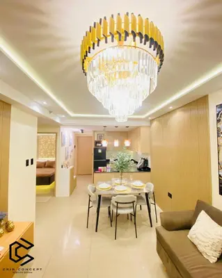 a dining room and living room with a chandelier at Serenity Suite Smart Condo 2 BR Balcony in Manila