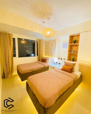 a bedroom with two beds and a window at Serenity Suite Smart Condo 2 BR Balcony in Manila