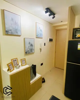 a room with a counter with pictures on the wall at Serenity Suite Smart Condo 2 BR Balcony in Manila