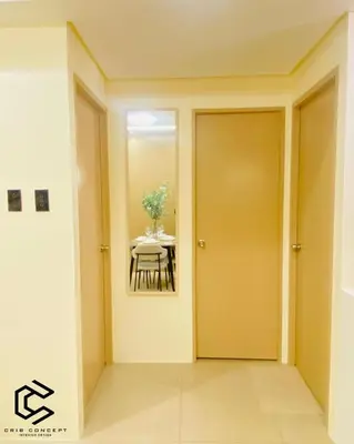 a dining room with a table and a mirror at Serenity Suite Smart Condo 2 BR Balcony in Manila