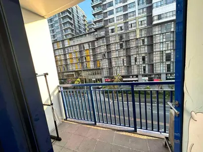 a balcony with a view of a large building at Sea Affordable staycation in Manila