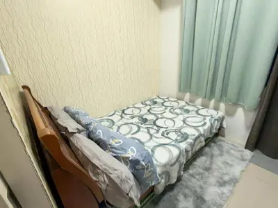 a small bed in a room with a window at Sea Affordable staycation in Manila