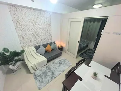 a living room with a couch and a table at Sea Affordable staycation in Manila
