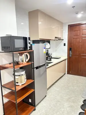 a kitchen with a refrigerator and a microwave at Sybay Suites twin double bed beside Okada near T3 MOA NAIA Ayala MSV1517H in Manila
