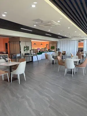 a dining room with tables and chairs and a bar at Sybay Suites twin double bed beside Okada near T3 MOA NAIA Ayala MSV1517H in Manila