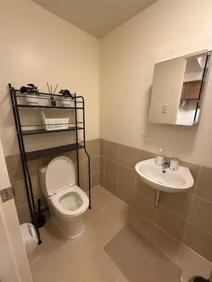 a bathroom with a toilet and a sink at 1BR Luxury Apartment The Camden Place in Manila