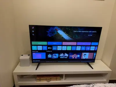a flat screen tv sitting on a white stand at 1BR Luxury Apartment The Camden Place in Manila