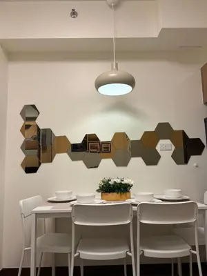 a dining room with a white table and chairs at 1BR Luxury Apartment The Camden Place in Manila