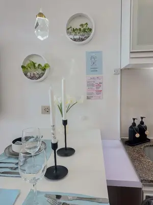 a kitchen counter with two candles and a wine glass at nJoy! Tropical Breeze at Venice Grand Canal in Manila