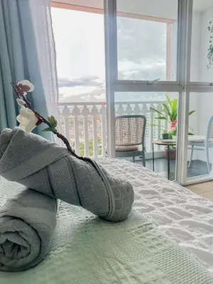 a pair of towels on a bed in a bedroom at nJoy! Tropical Breeze at Venice Grand Canal in Manila