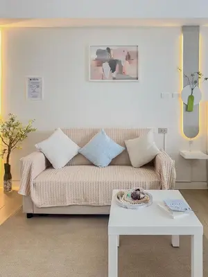 a living room with a couch and a table at nJoy! Tropical Breeze at Venice Grand Canal in Manila