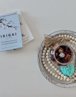 a book next to a basket of beads and a book at nJoy! Tropical Breeze at Venice Grand Canal in Manila