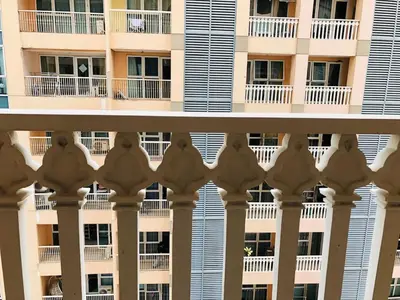 an apartment building with white balconies and windows at Charming 1BR with Balcony near Venice mall&BGC in Manila