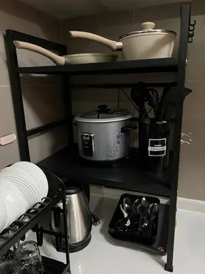 a shelf with pots and pans on it in a kitchen at Thailand Theme 1BR Free Pool Gym Internet Netflix Sunshine 100 T3 Pioneer Mandaluyong in Manila