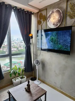 a living room with a flat screen tv on a wall at Thailand Theme 1BR Free Pool Gym Internet Netflix Sunshine 100 T3 Pioneer Mandaluyong in Manila