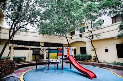a playground with a red slide in front of a building at Althea's Homestay at Forebeswood Height in Manila