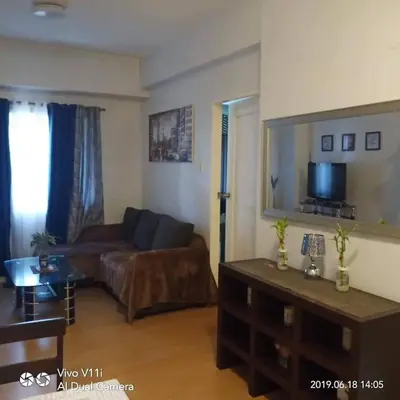 a living room with a couch and a tv at Althea's Homestay at Forebeswood Height in Manila