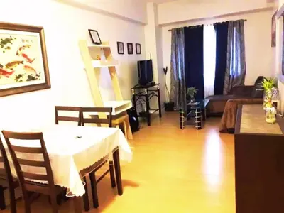 a living room with a table and a couch at Althea's Homestay at Forebeswood Height in Manila